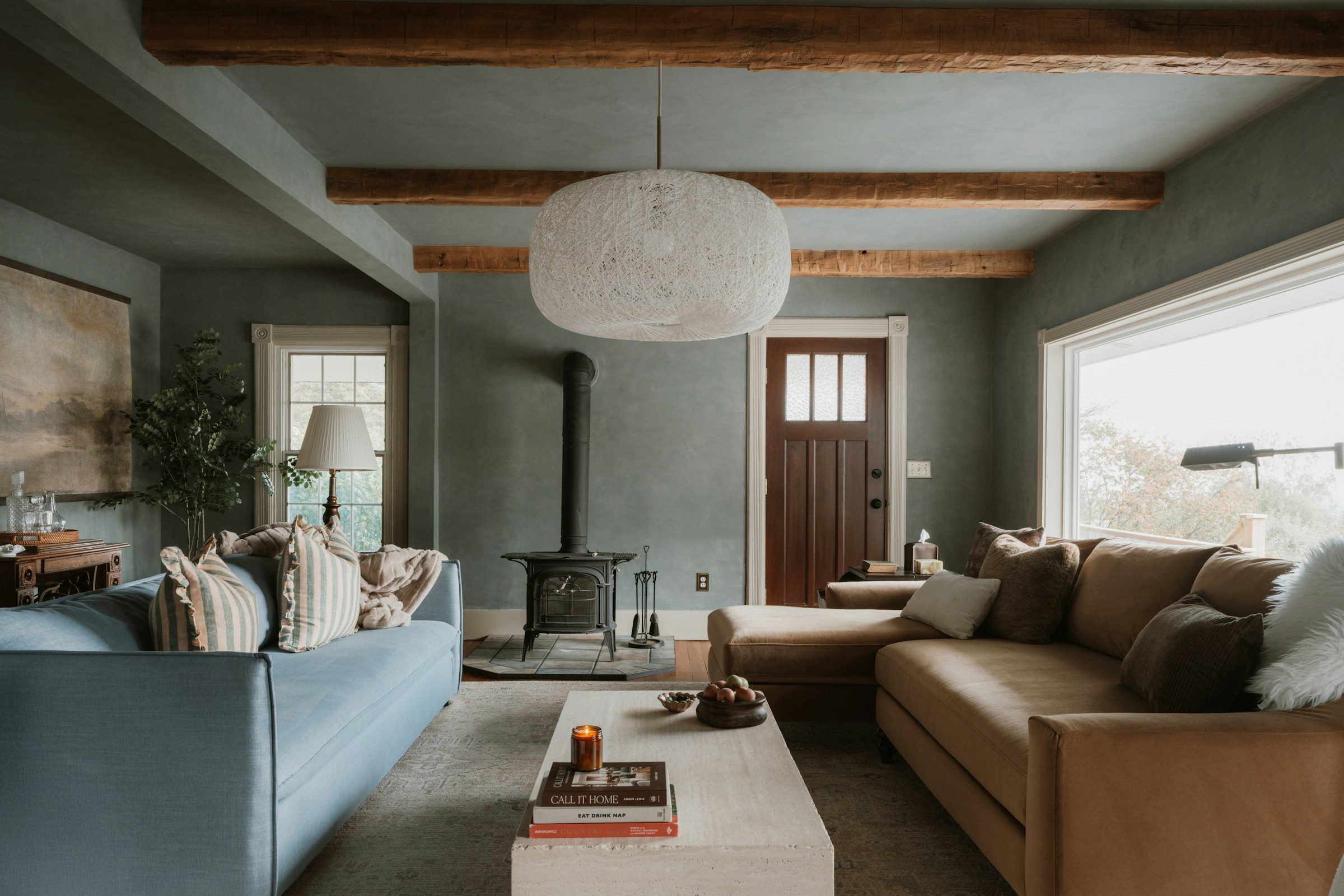 An open-plan living room with exposed beams
